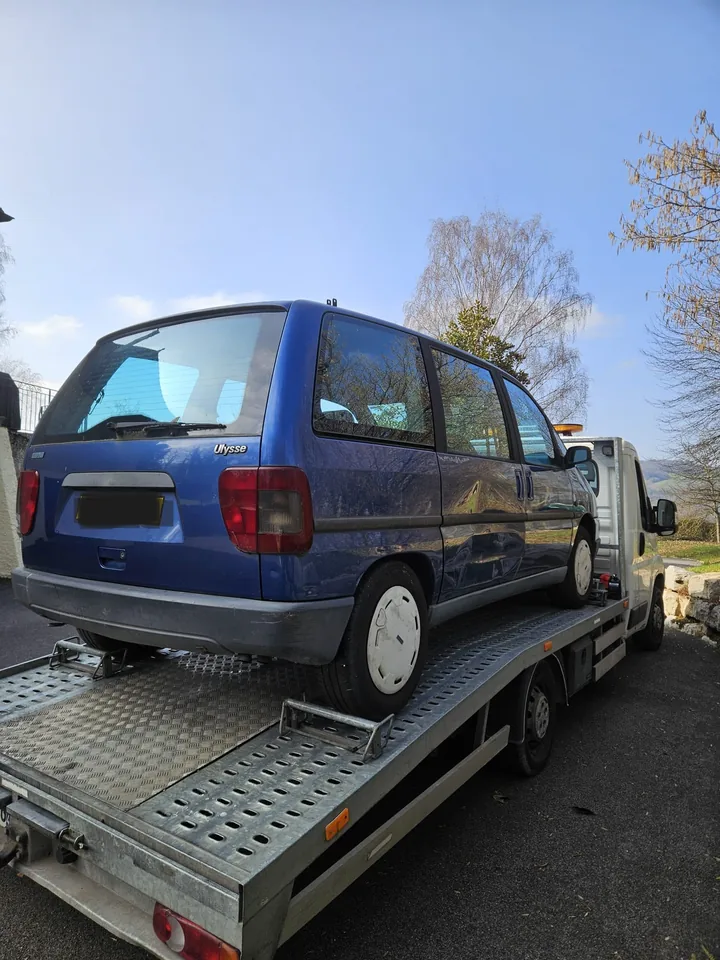 Fiat Ulysse vu de l’arrière sur le plateau métallique d’un camion.