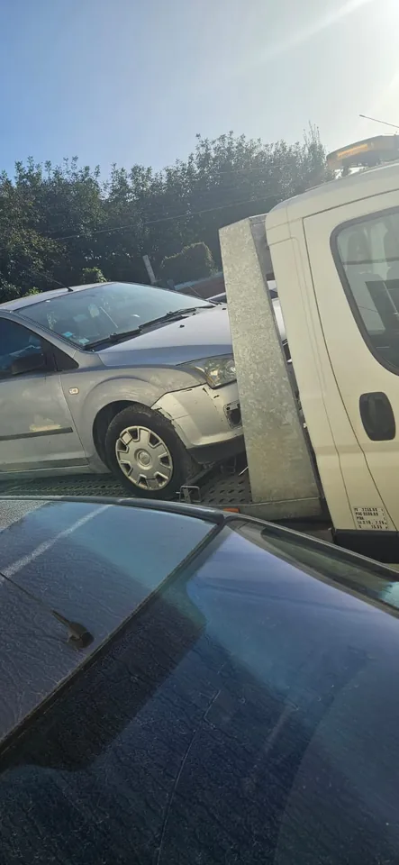 Ford Focus avec des marques au pare-chocs avant sur le plateau d’un camion.